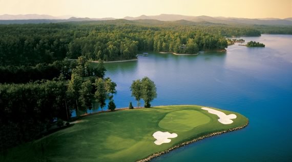 a golf course with a lake and trees
